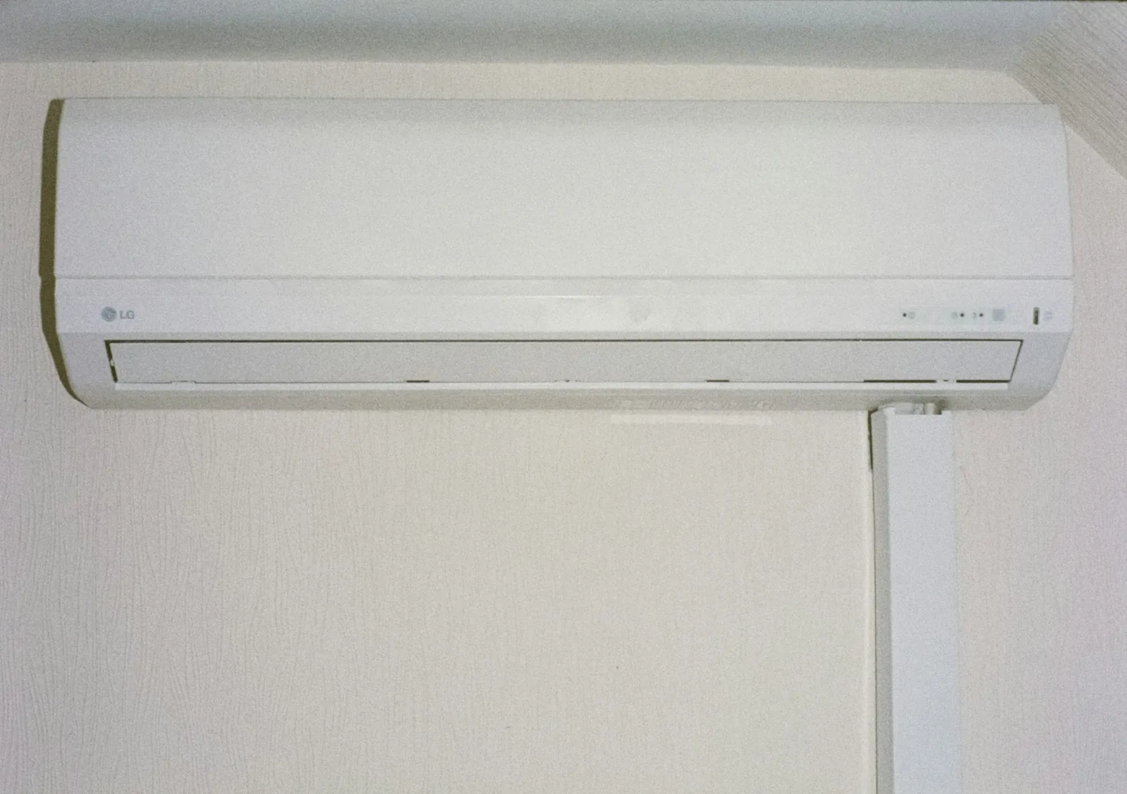 A white wall-mounted air conditioning unit
